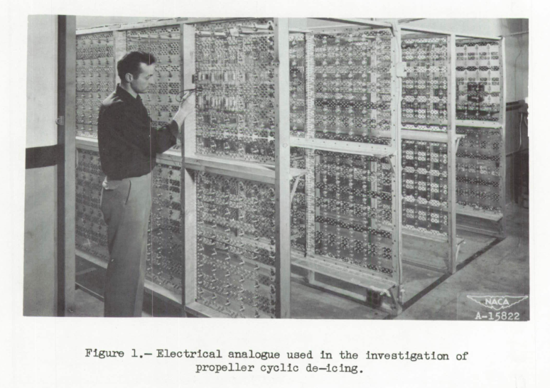 Figure 1. Electrical analogue used in the investigation of propeller
cyclic de—Icing.
A man stands in front of a large rack of electrical circuits. 
Three more similar racks are in the background.
